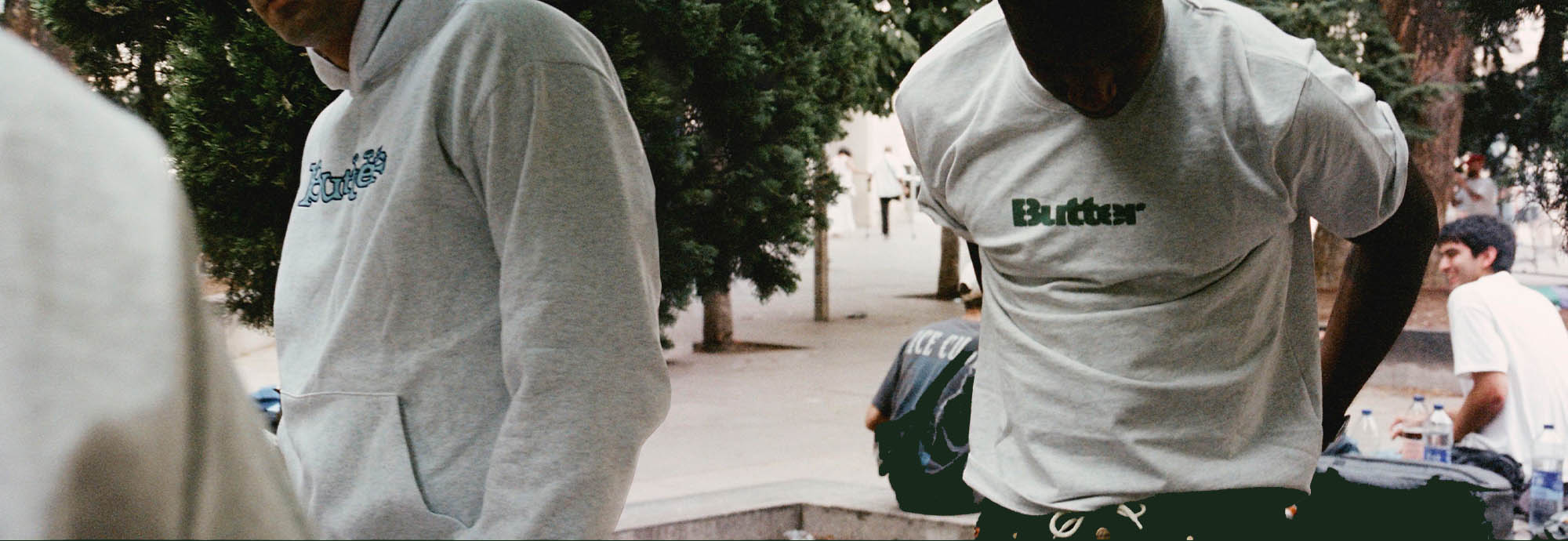 Butter Goods models in grey t-shirt and grey hoodie