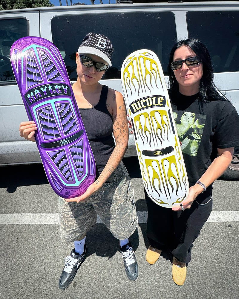 Hayley and Nicole holding skateboard decks